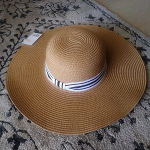 Straw hat with white and black ribbon